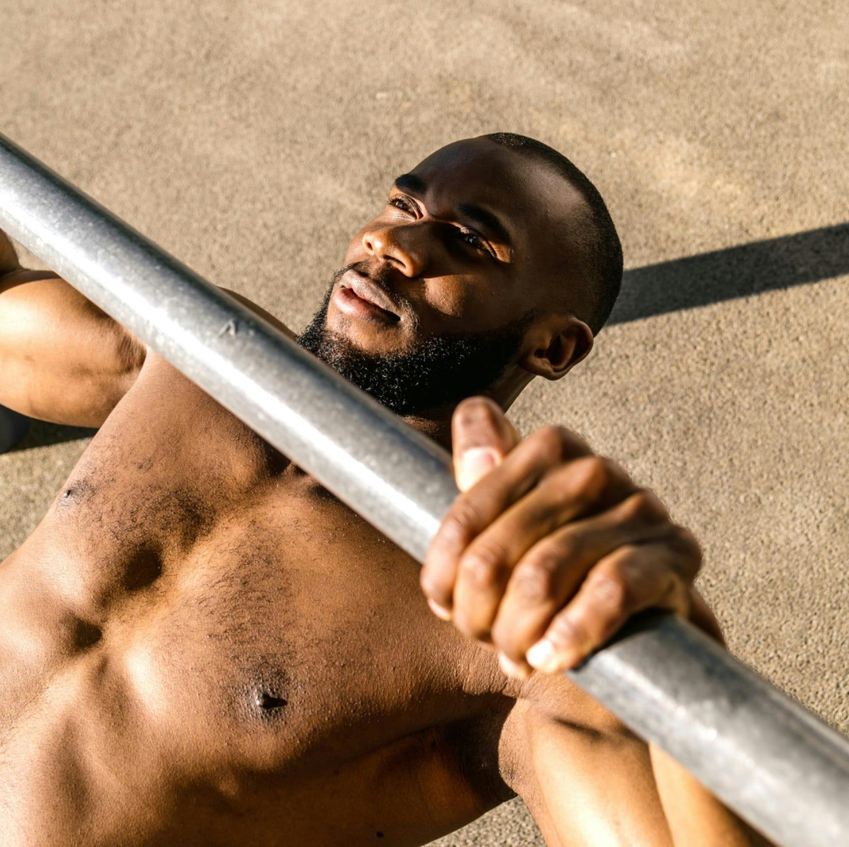 guy lifting weight bench press trt