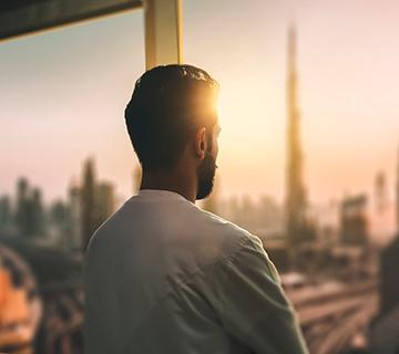 man looking out window